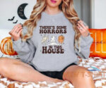 there is some horrors in this house halloween home party unisex sweatshirt 0.jpg