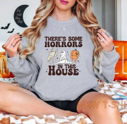 there is some horrors in this house halloween home party unisex sweatshirt 0.jpg